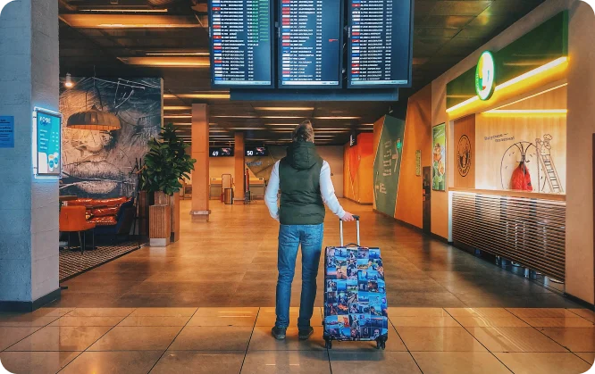 Traveler with luggage at airport terminal