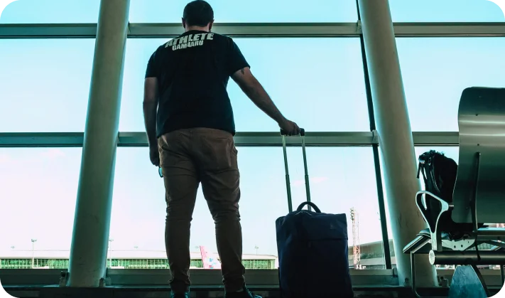 Passenger waiting at airport with luggage