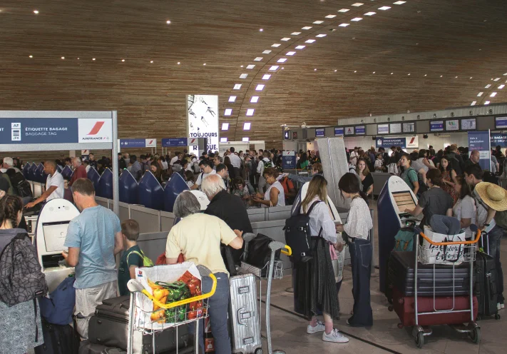 Crowded airport terminal with passengers and luggage